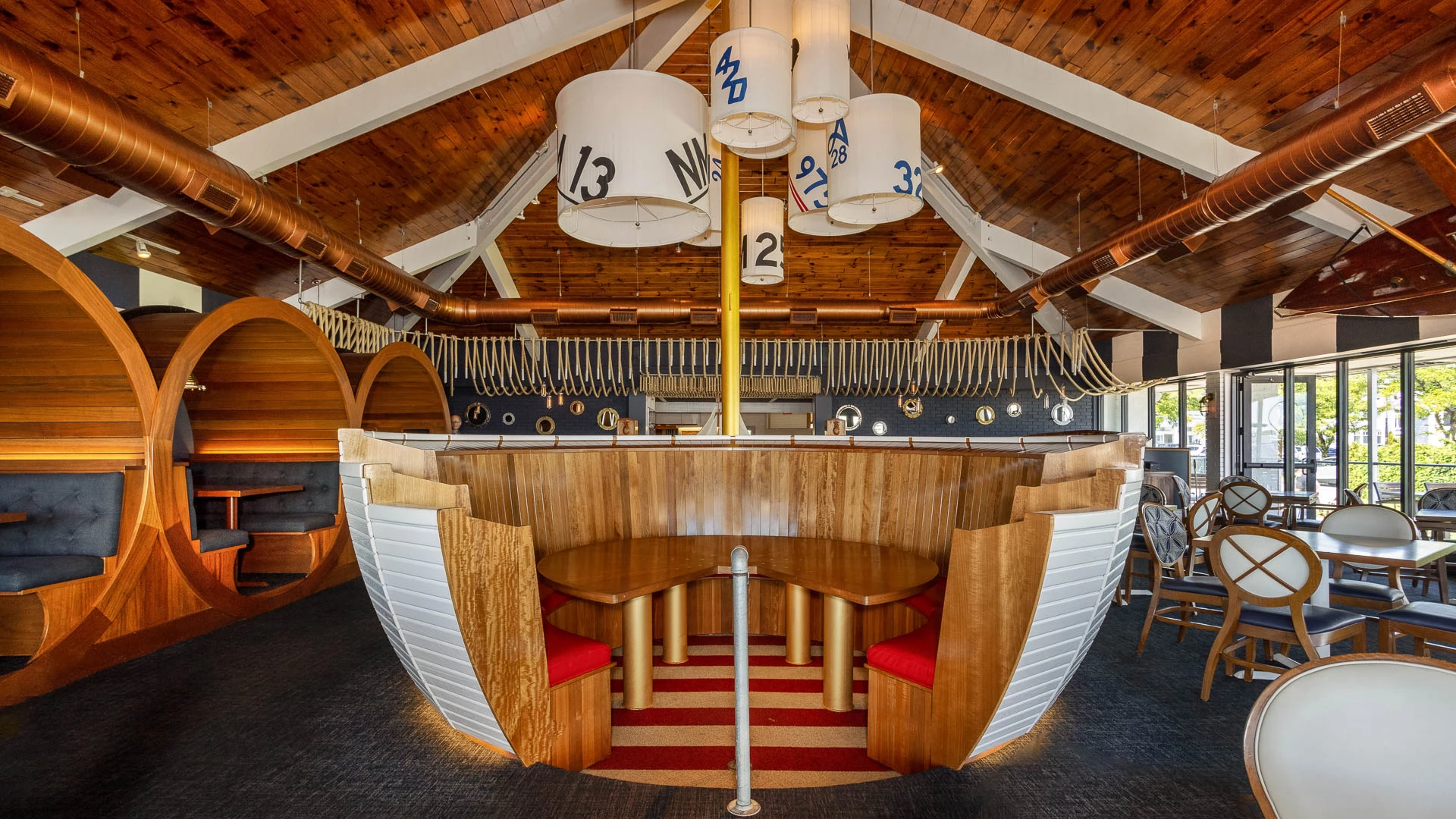 The Pointer Room's boat-hull bar under sailcloth pendant lights and nautical decor