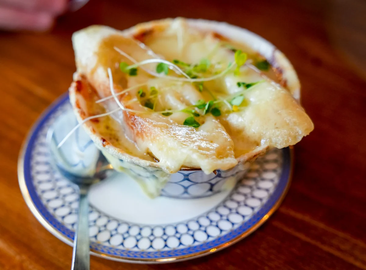 French onion soup topped with melted, broiled cheese and micro greens
