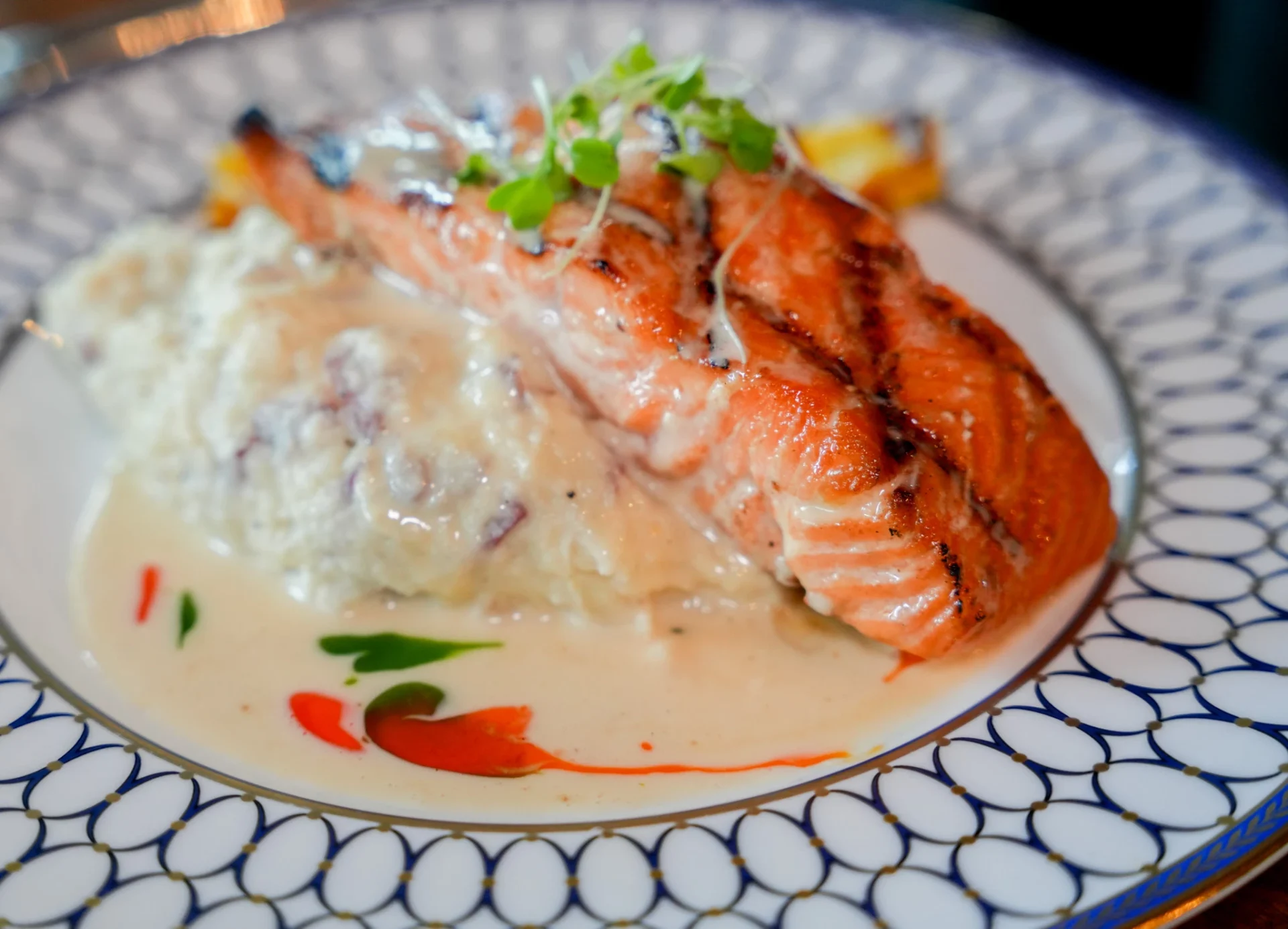 Grilled salmon fillet over whipped potatoes in a cream sauce