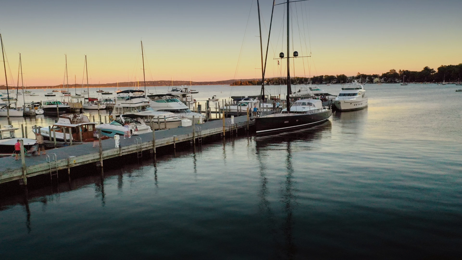Sailboats moored in Harbor Springs marina at sunset